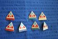 House captain badges - Red - Karumba house; Navy blue - Aranda; Aqua - Pinjarra; White - Barada.